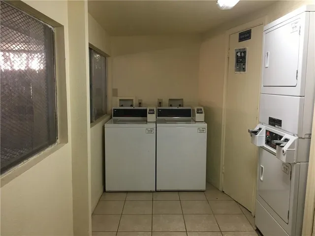 a utility room with cabinets washer and dryer