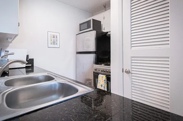 a kitchen with a sink and a microwave