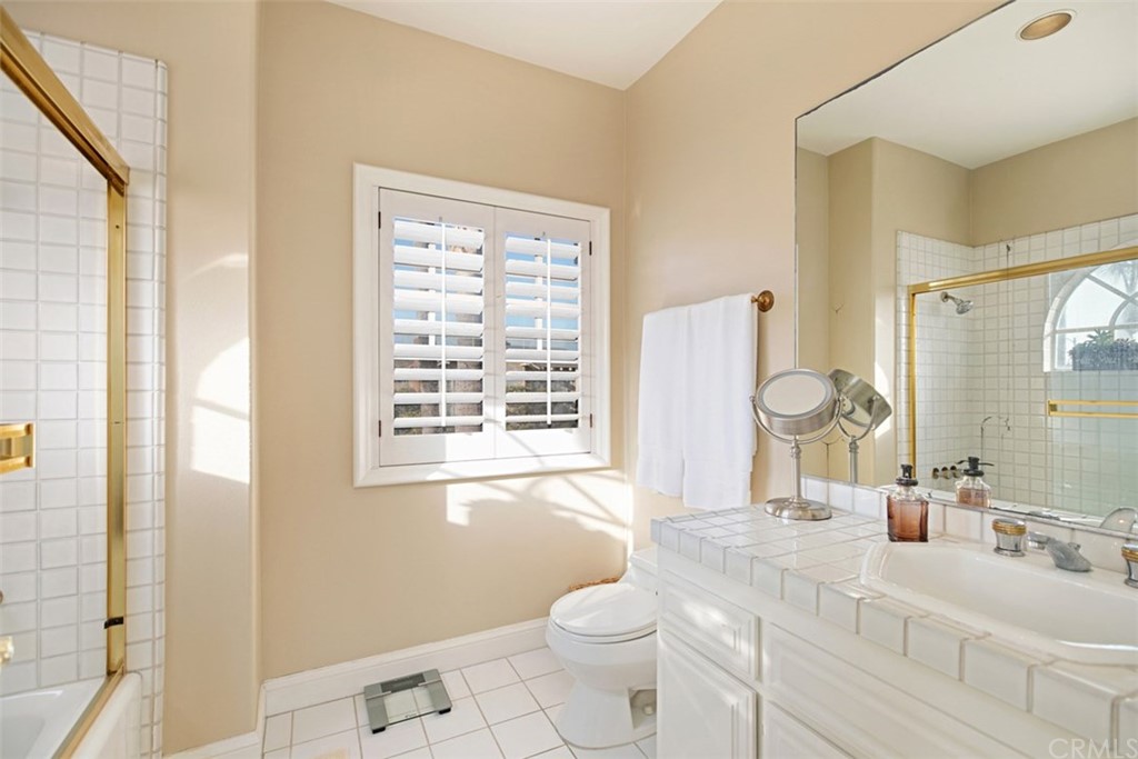 24486 Alta Vista Drive Dana Point, CA 92629 - Photo 13 of 15 a bathroom with a sink toilet a mirror and shower