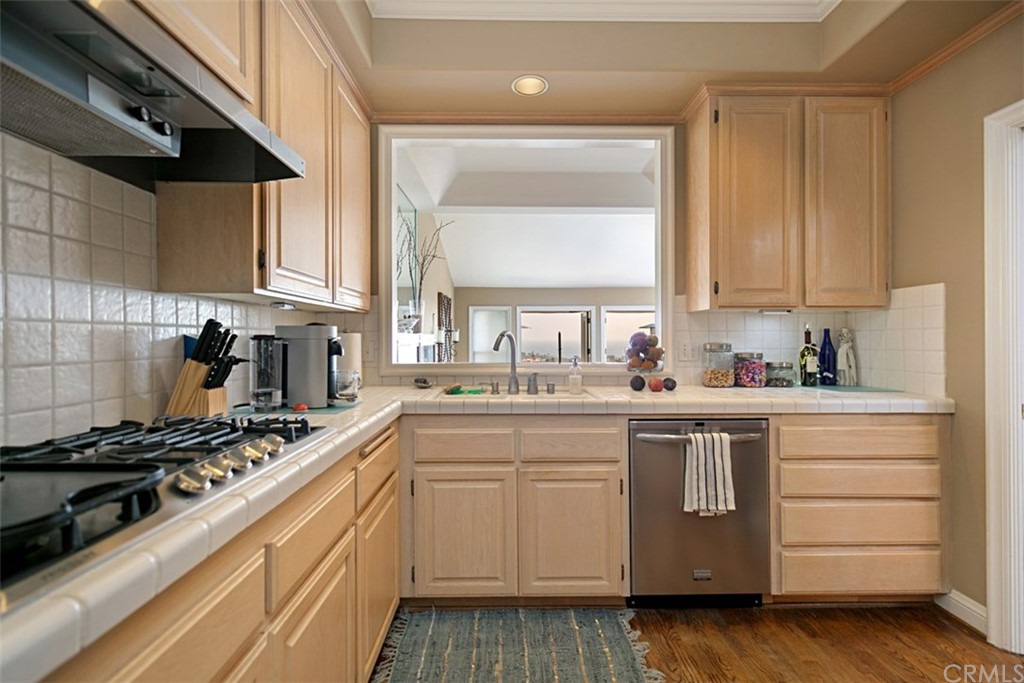 24486 Alta Vista Drive Dana Point, CA 92629 - Photo 6 of 15 a kitchen with a sink stove and cabinets