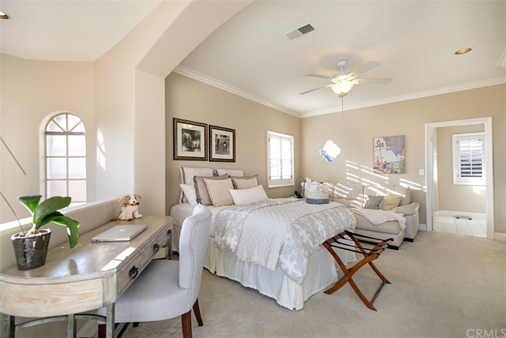 24486 Alta Vista Drive Dana Point, CA 92629 - Photo 10 of 15 a bedroom with a bed and a chandelier