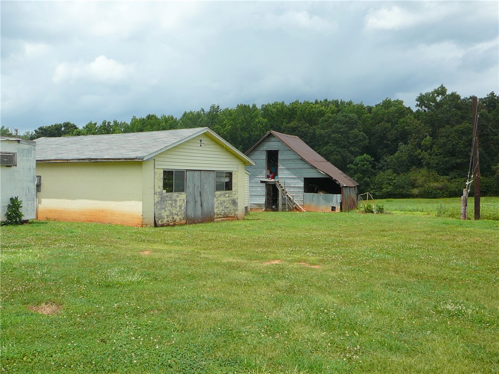 1430 Grady Hall Road Anderson, SC 29626 - Photo 3 of 14 A spacious yard surrounds multiple utilitarian outbuildings.