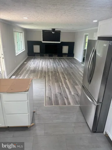 a view of kitchen with furniture and a refrigerator