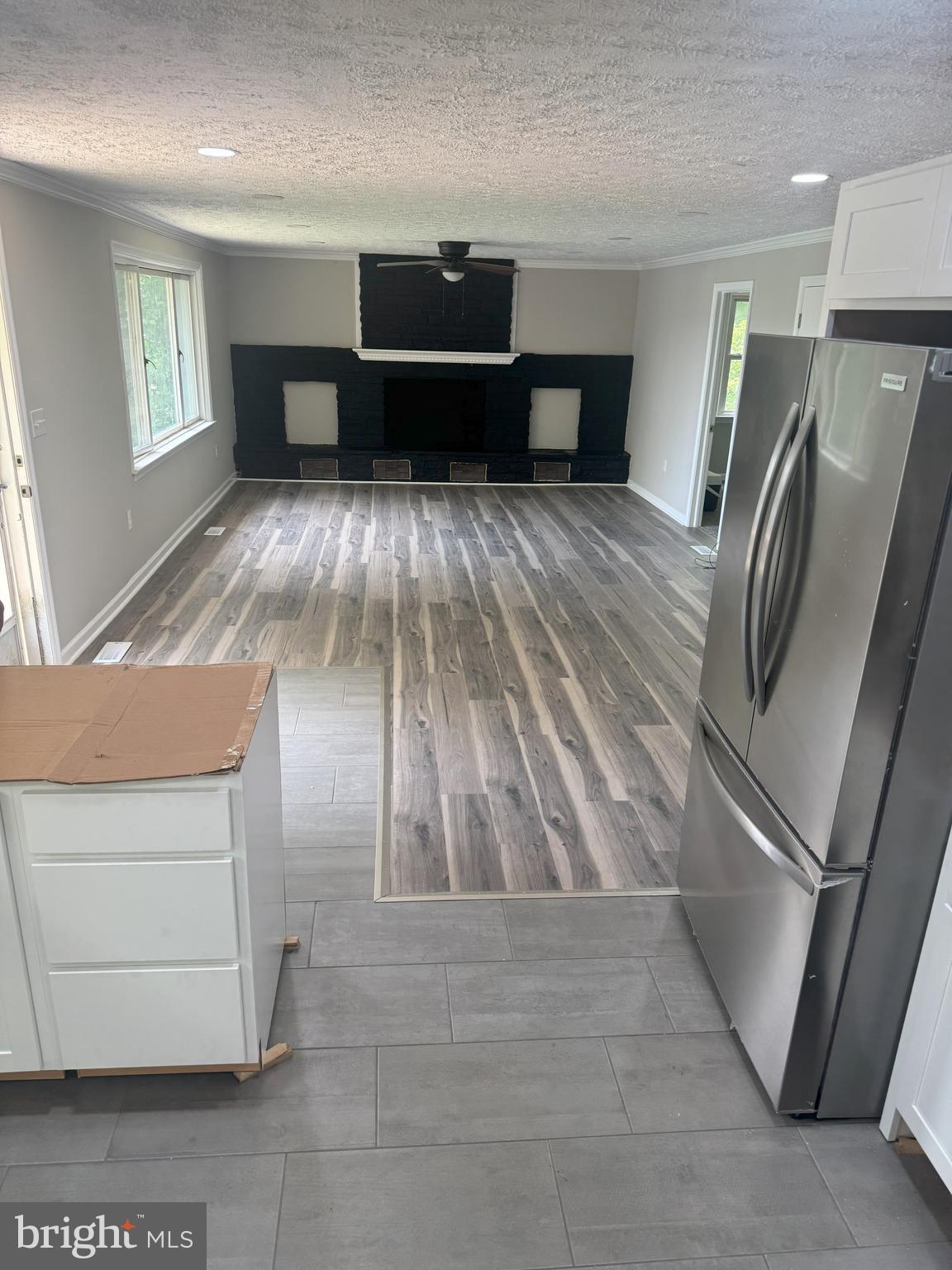 a view of kitchen with furniture and a refrigerator