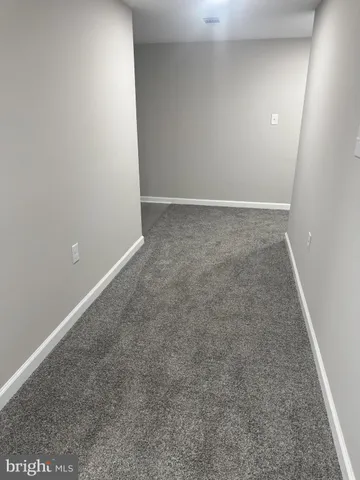 a white toilet sitting next to a bathroom sink and vanity