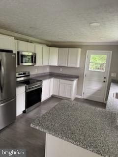 408 Cherry Hill Road Street, MD 21154 - Photo 2 of 17 a kitchen with stainless steel appliances granite countertop a sink stove and refrigerator