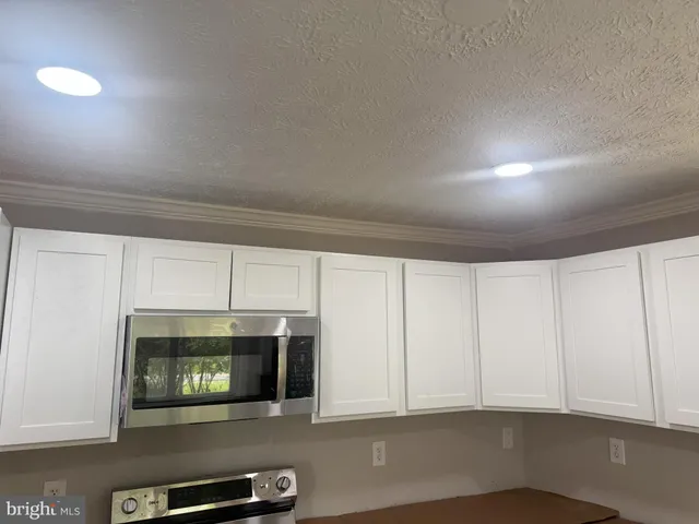 a view of an empty room with a fireplace