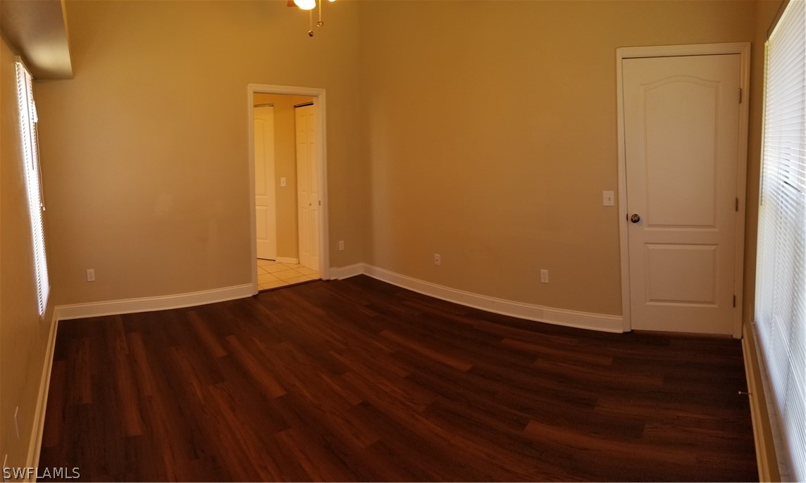 8149 Anhinga Road Fort Myers, FL 33967 - Photo 5 of 14 a view of an empty room with wooden floor and a window