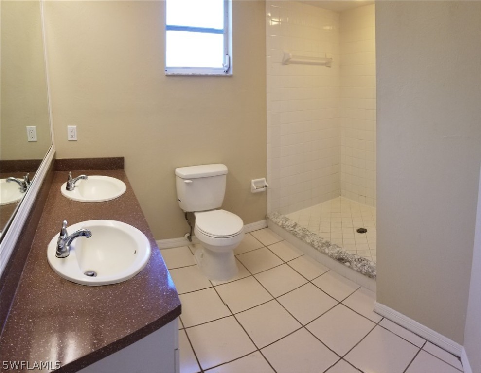 8149 Anhinga Road Fort Myers, FL 33967 - Photo 6 of 14 a bathroom with a sink a toilet and a mirror
