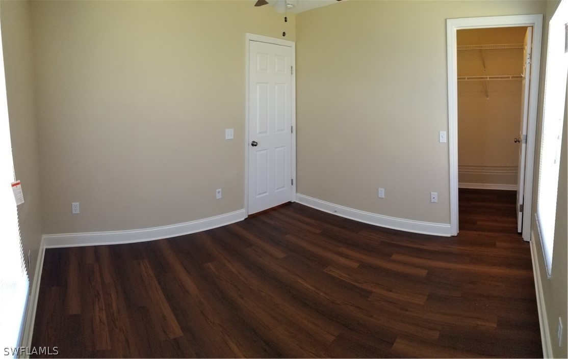 8149 Anhinga Road Fort Myers, FL 33967 - Photo 8 of 14 a view of an empty room with wooden floor and a window