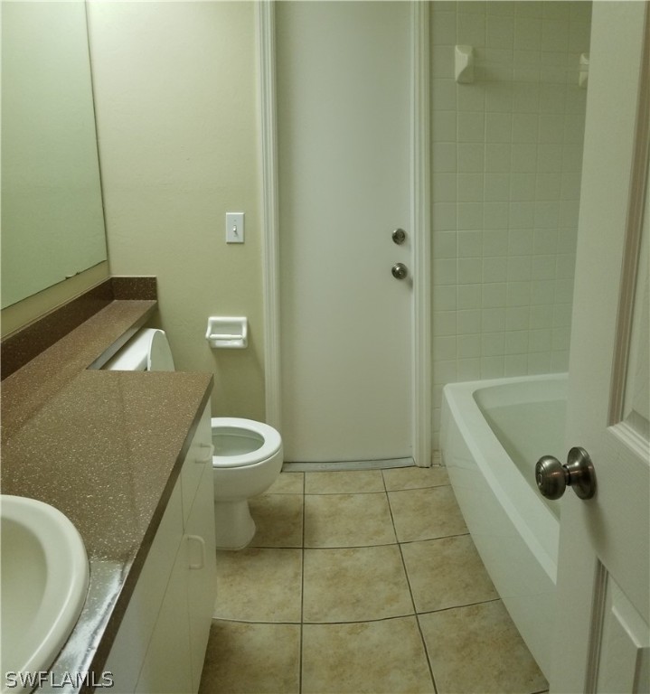 8149 Anhinga Road Fort Myers, FL 33967 - Photo 9 of 14 a bathroom with a granite countertop bathtub and toilet