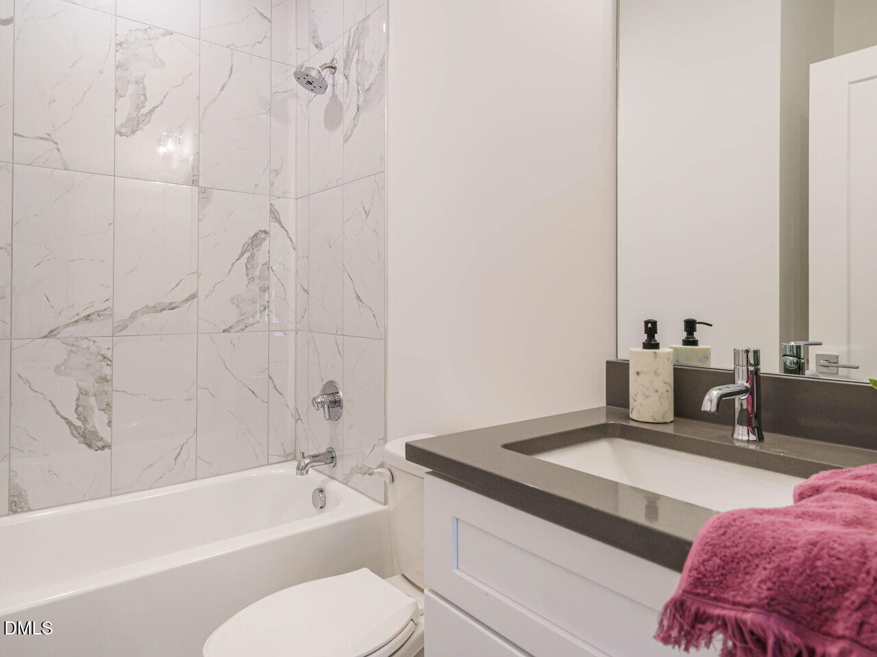 1527 Urban Trace Lane Raleigh, NC 27608 - Photo 23 of 37 a bathroom with a granite countertop sink a toilet and bathtub