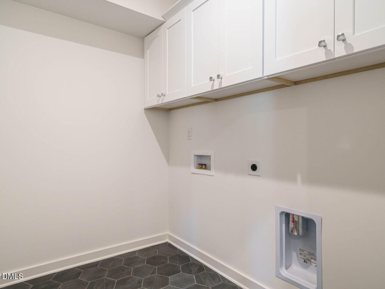 1527 Urban Trace Lane Raleigh, NC 27608 - Photo 25 of 37 a view of storage and utility room with cabinets