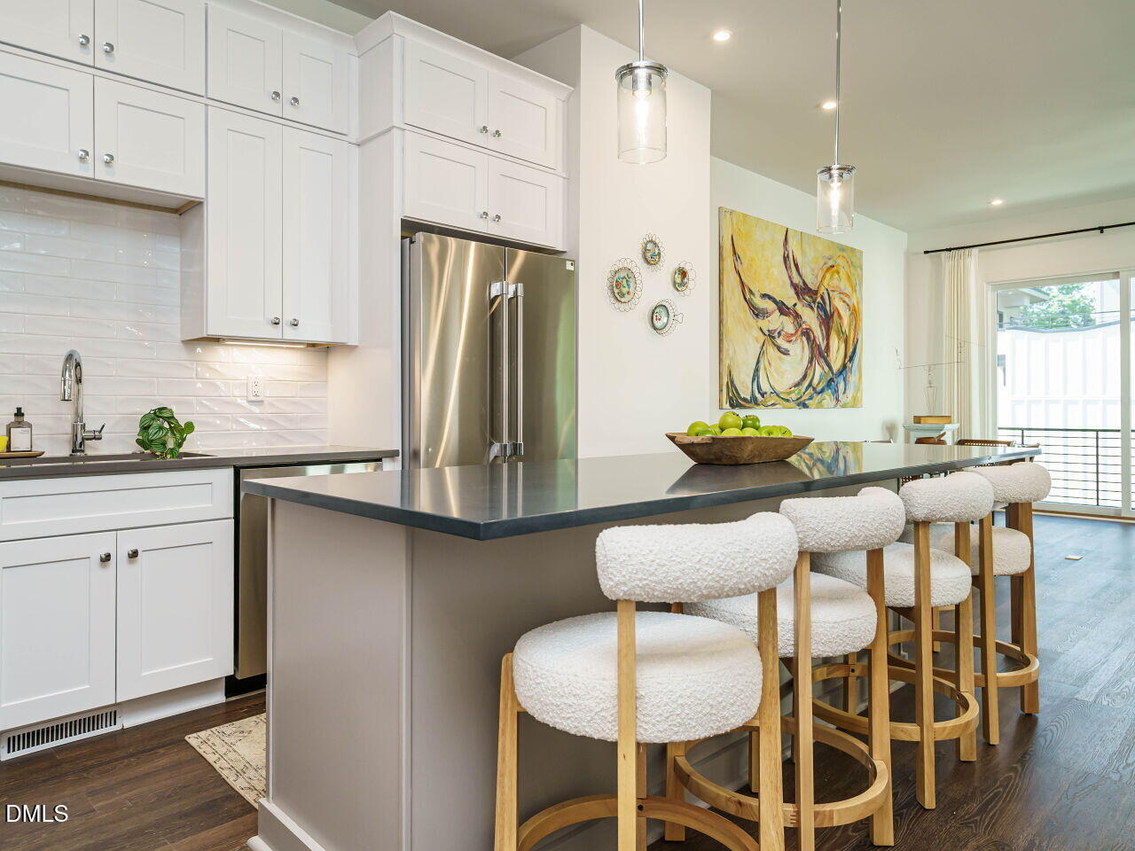 1527 Urban Trace Lane Raleigh, NC 27608 - Photo 4 of 37 a kitchen with stainless steel appliances kitchen island granite countertop a table and chairs in it