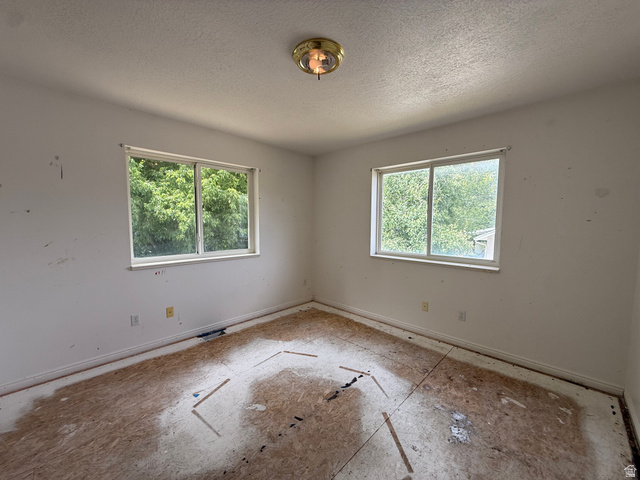 838 East Mountain Road Logan, UT 84321 - Photo 20 of 37 Interior space featuring two windows with outdoor scenery, baseboard trim, and a ceiling-mounted light fixture