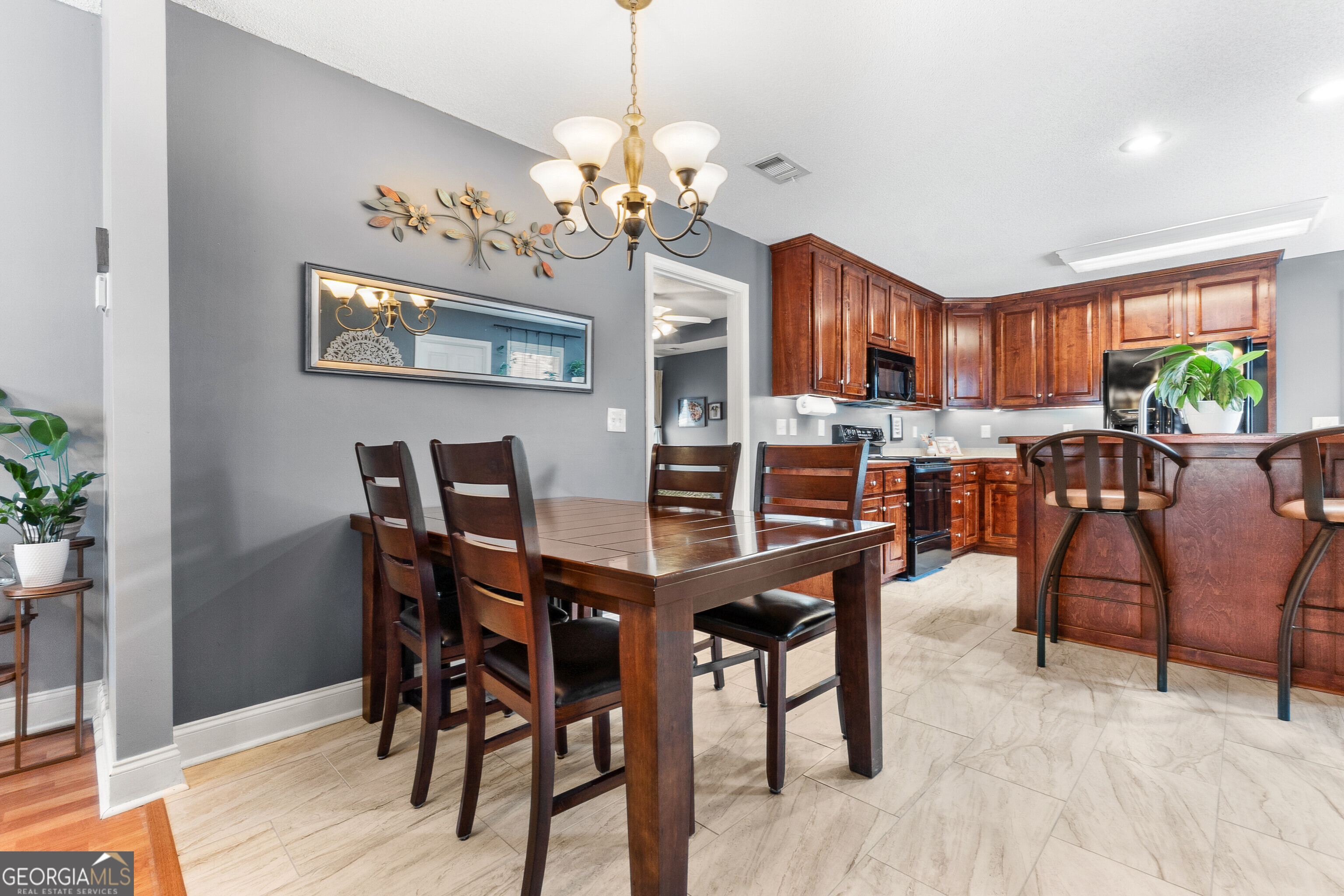 418 Covington Cove Byron, GA 31008 - Photo 11 of 47 a view of a dining room with furniture a chandelier and wooden floor