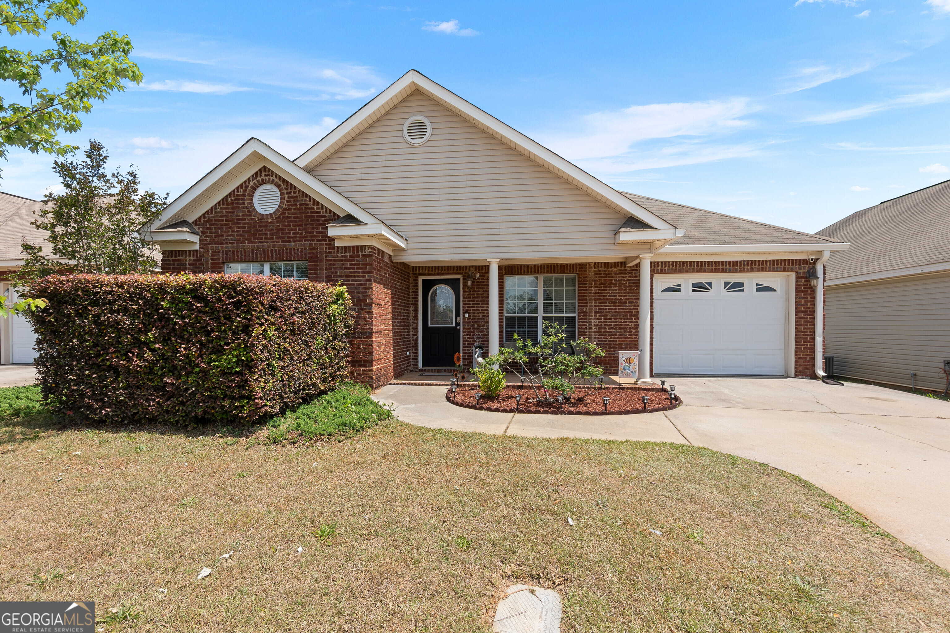 418 Covington Cove Byron, GA 31008 - Photo 2 of 47 a front view of a house with a yard and garage