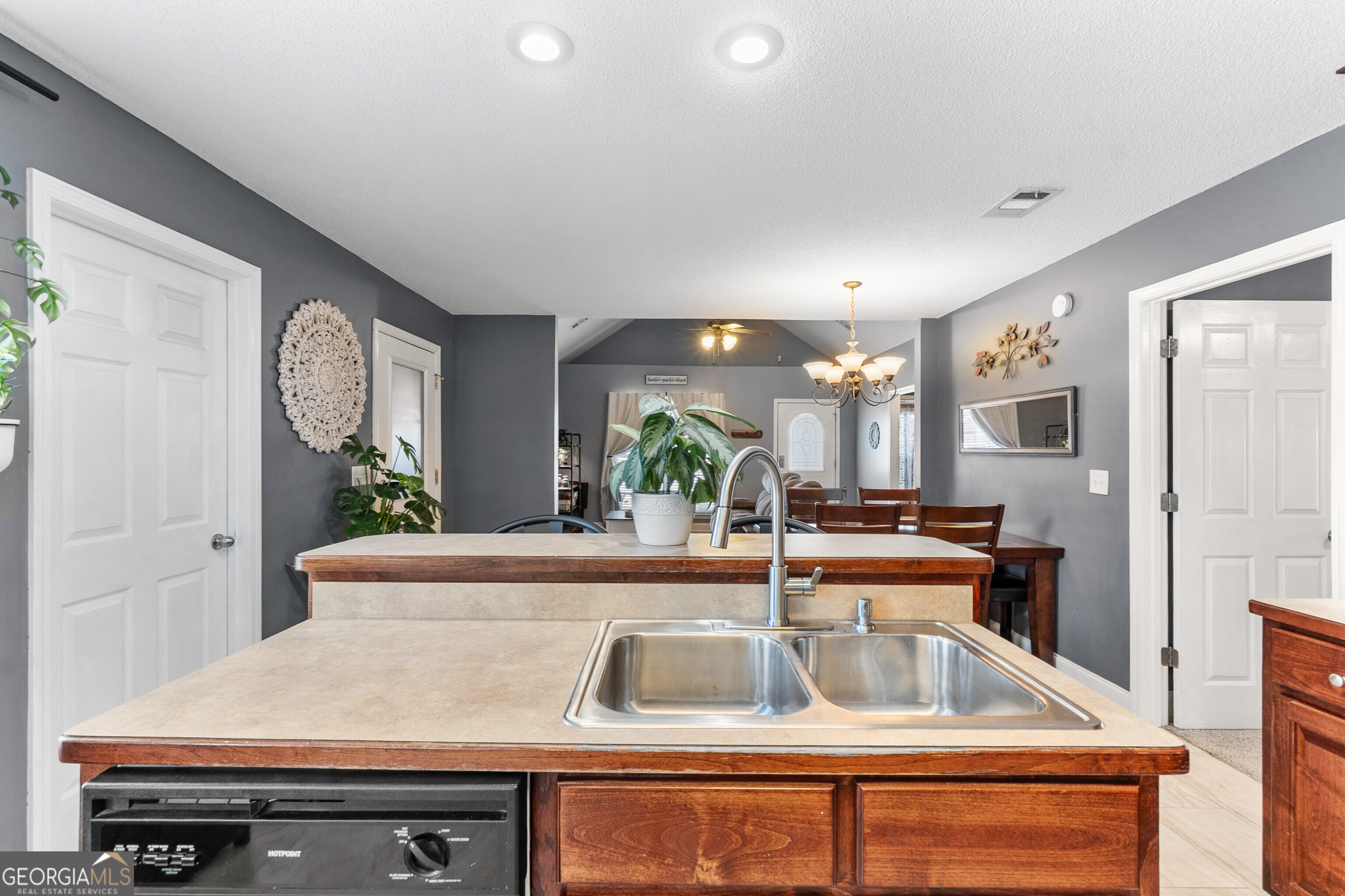 418 Covington Cove Byron, GA 31008 - Photo 22 of 47 a kitchen with a sink and a refrigerator