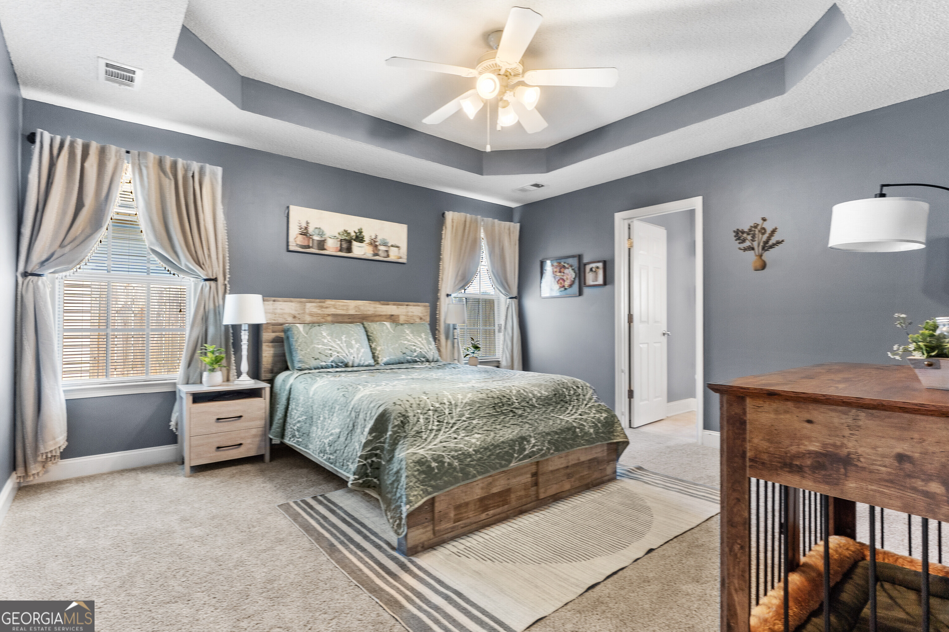 418 Covington Cove Byron, GA 31008 - Photo 23 of 47 a spacious bedroom with a bed and a chandelier