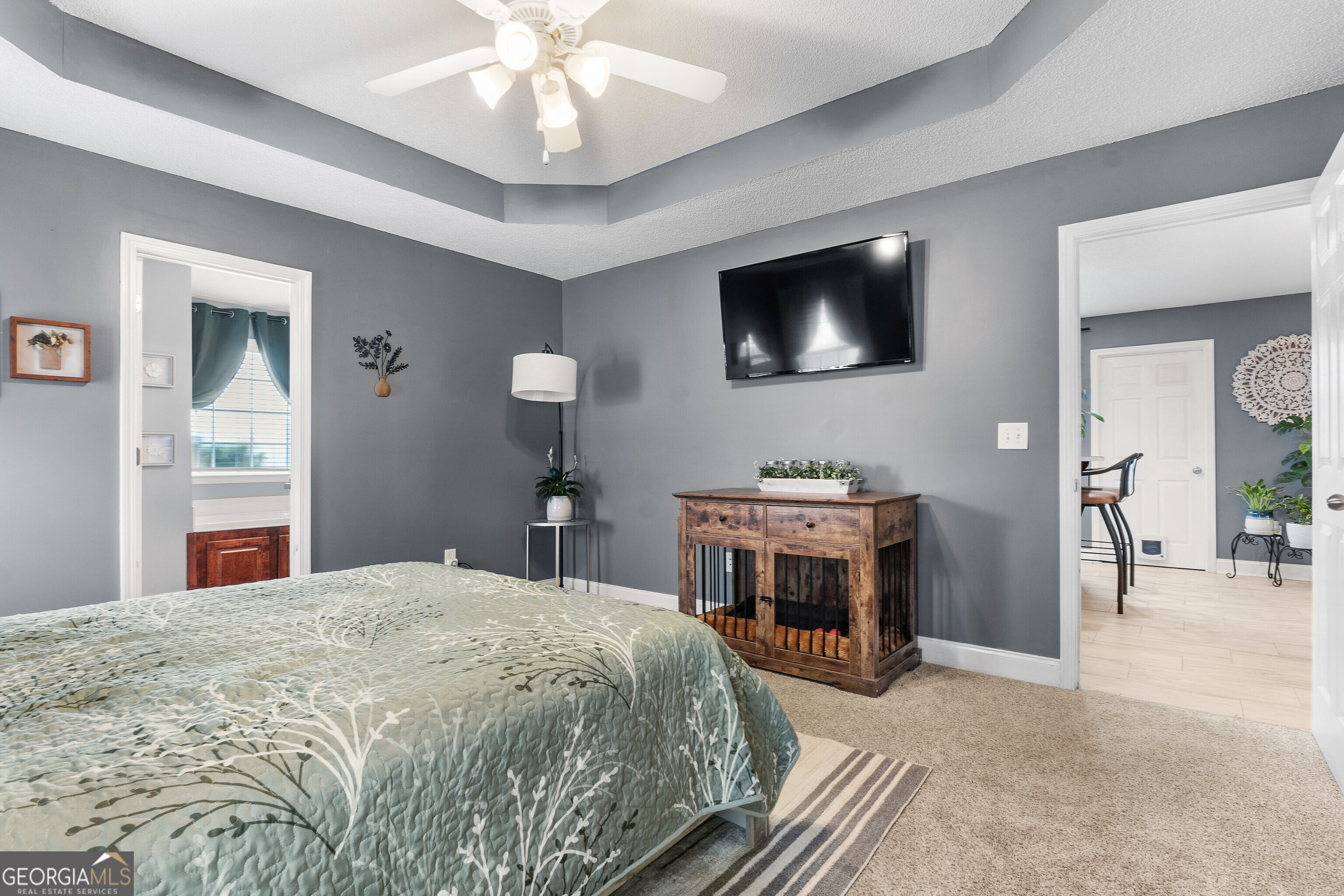 418 Covington Cove Byron, GA 31008 - Photo 27 of 47 a bedroom with a bed and a flat screen tv