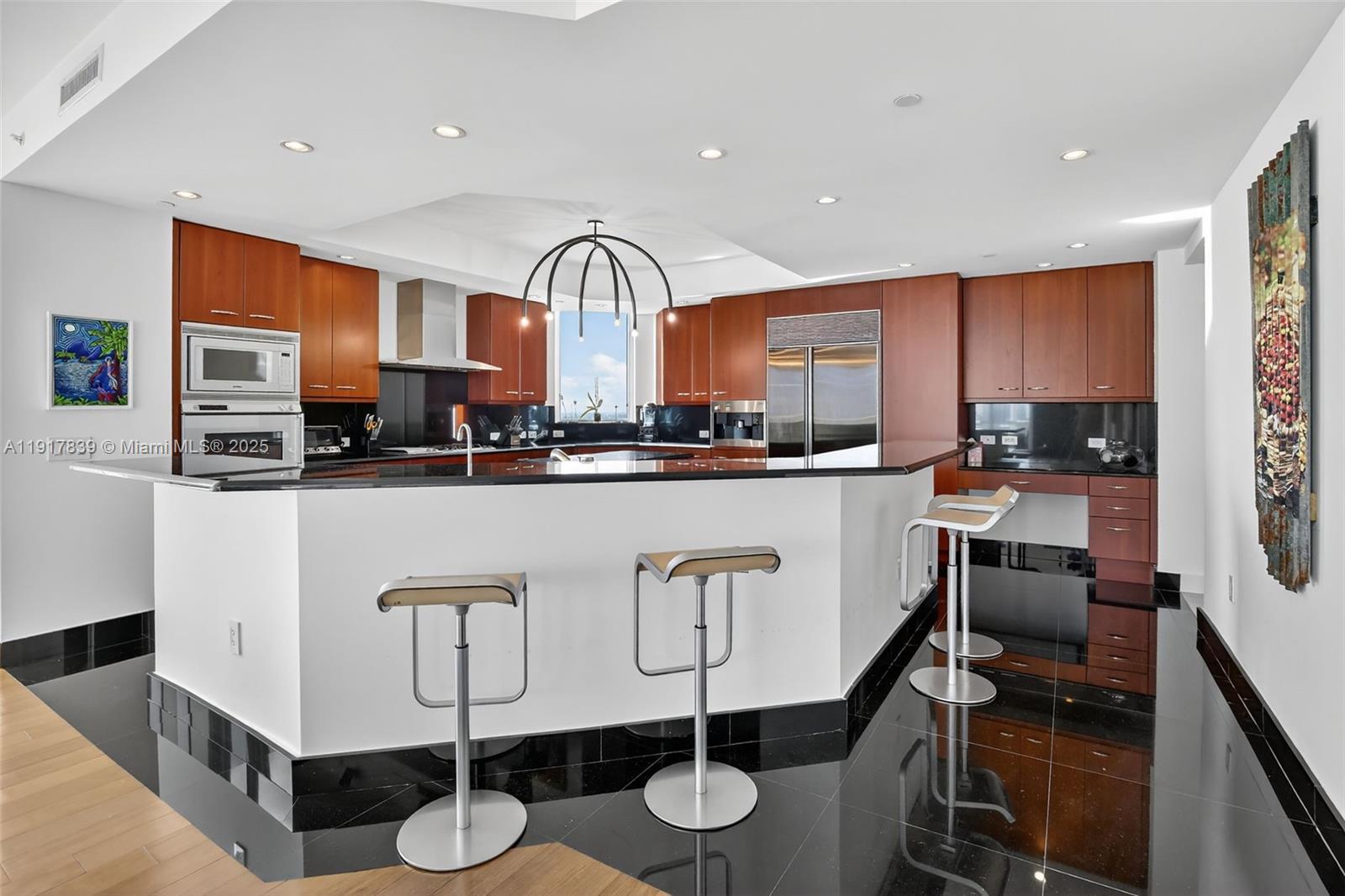 6000 Island Boulevard, Unit 1208 Aventura, FL 33160 - Photo 12 of 50 a kitchen with stainless steel appliances granite countertop a sink and cabinets