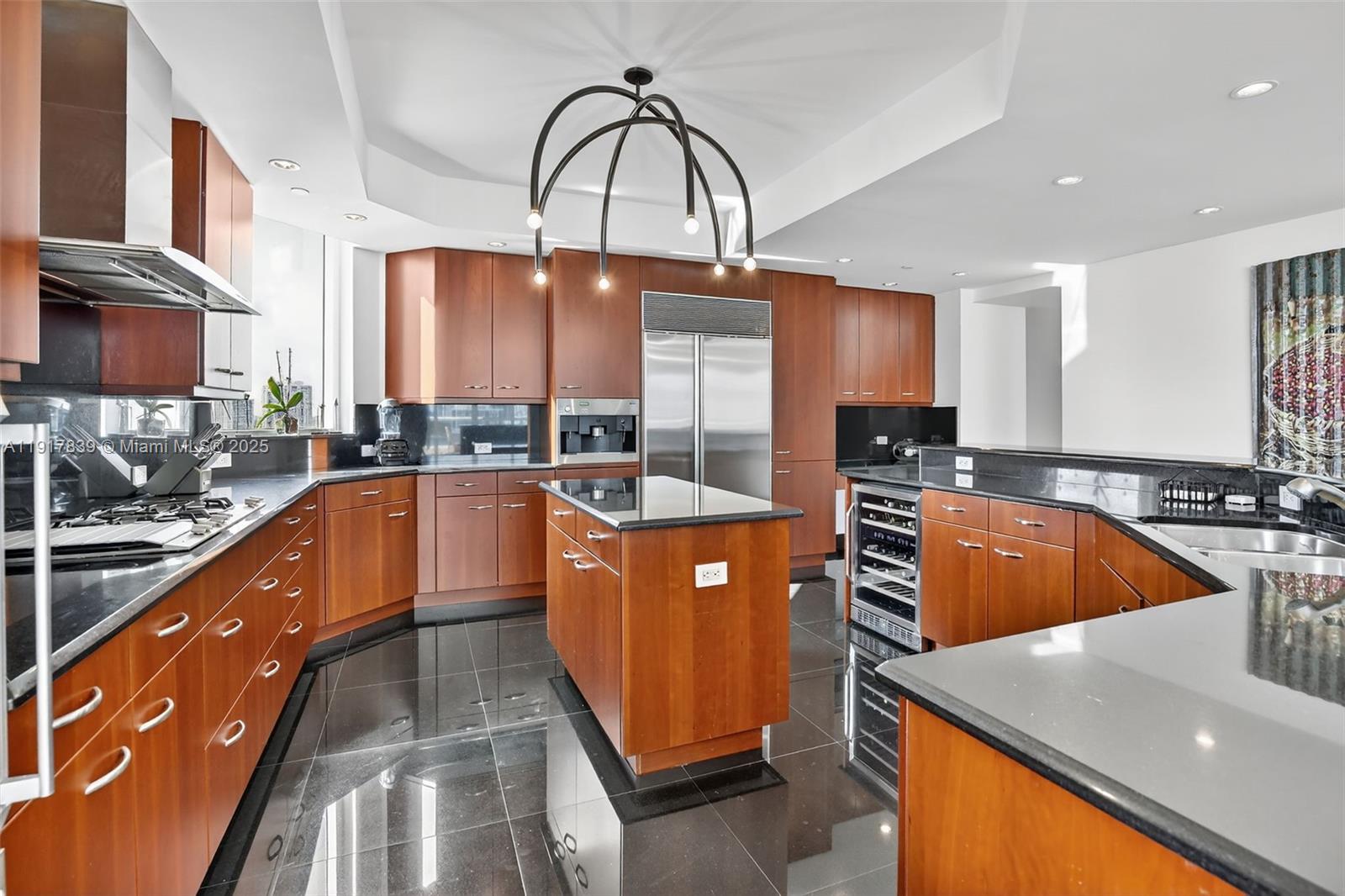 6000 Island Boulevard, Unit 1208 Aventura, FL 33160 - Photo 13 of 50 a kitchen with stainless steel appliances granite countertop a sink a stove and a microwave