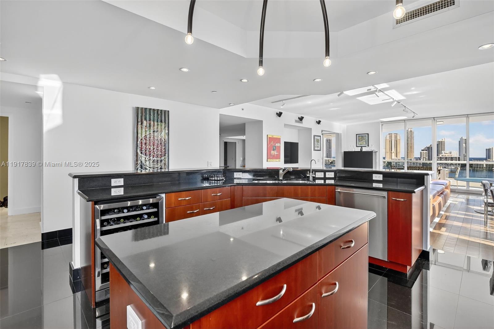 6000 Island Boulevard, Unit 1208 Aventura, FL 33160 - Photo 15 of 50 a large kitchen with stainless steel appliances granite countertop a sink a stove and a refrigerator