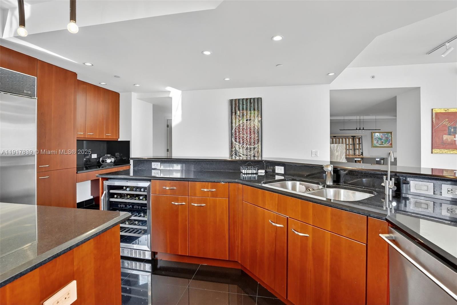 6000 Island Boulevard, Unit 1208 Aventura, FL 33160 - Photo 16 of 50 a kitchen with stainless steel appliances granite countertop a sink stove and refrigerator