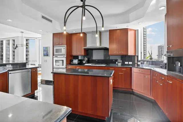 a kitchen with stainless steel appliances a sink counter space and a window
