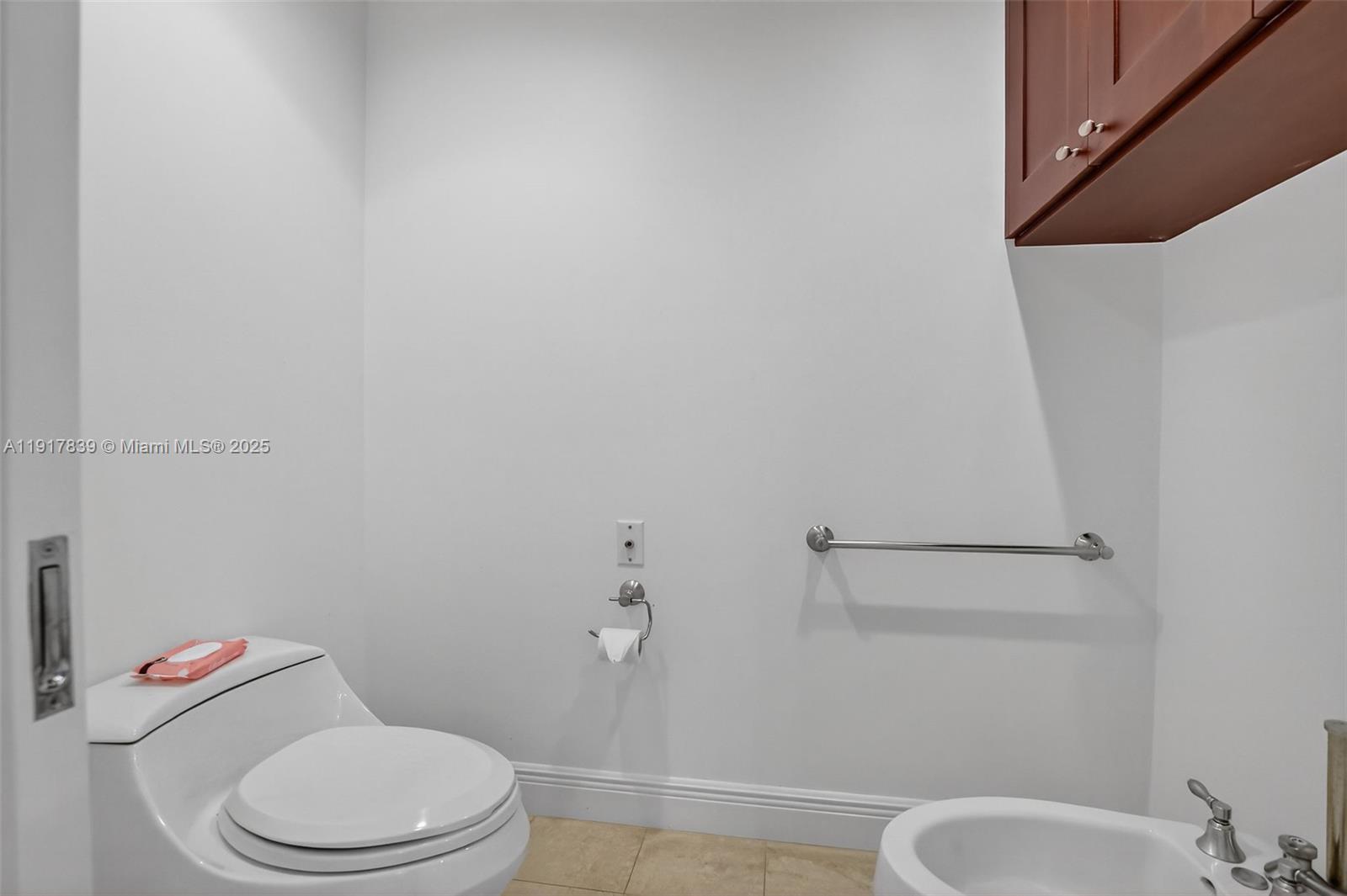 6000 Island Boulevard, Unit 1208 Aventura, FL 33160 - Photo 25 of 50 a white toilet sitting next to a bath tub