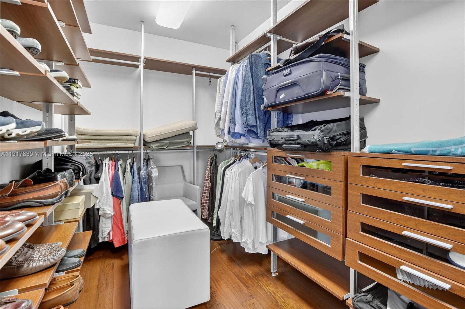 6000 Island Boulevard, Unit 1208 Aventura, FL 33160 - Photo 26 of 50 a view of walk in closet with clothes and shoes