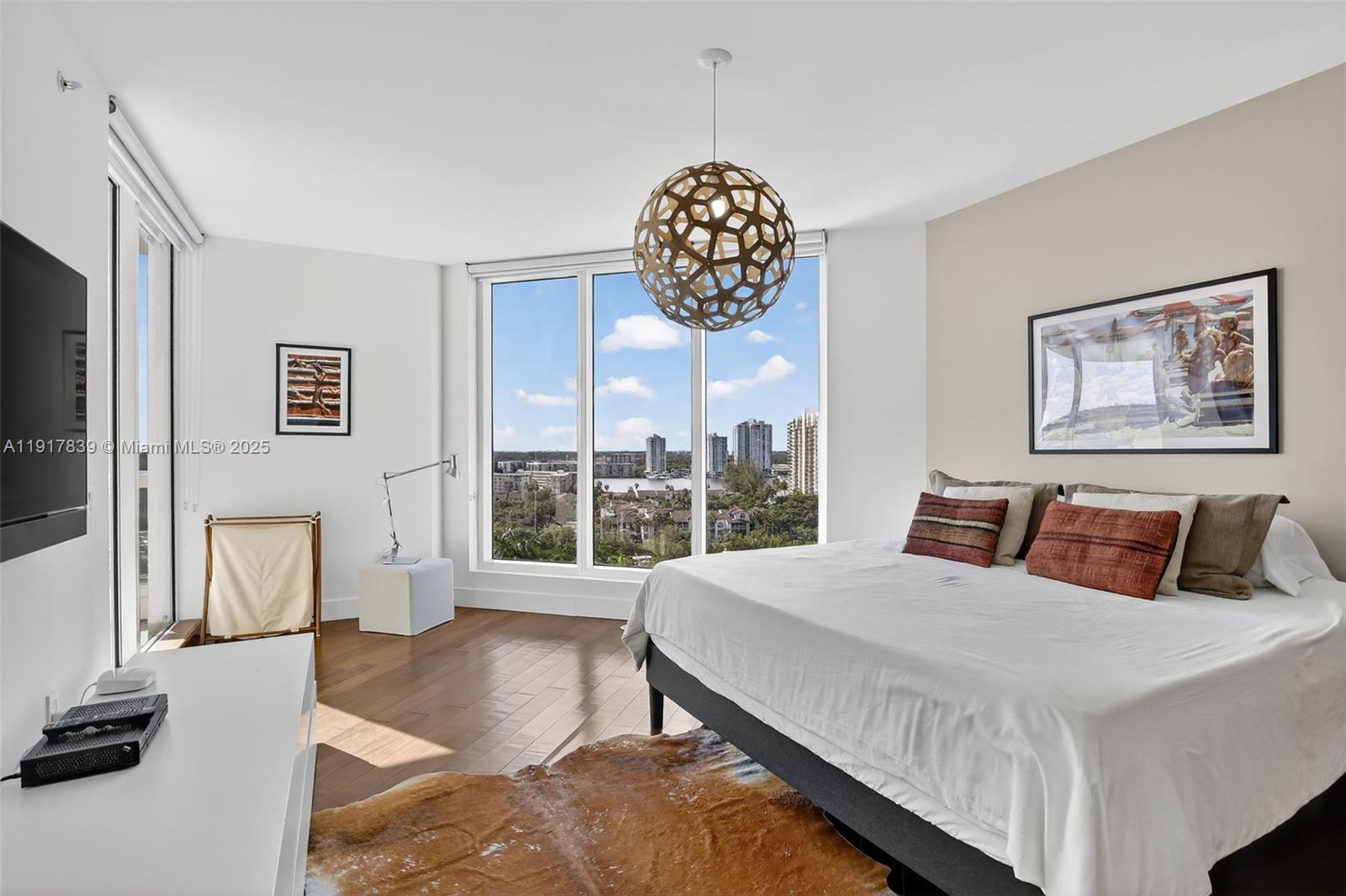 6000 Island Boulevard, Unit 1208 Aventura, FL 33160 - Photo 27 of 50 a bedroom with a large bed and a large window