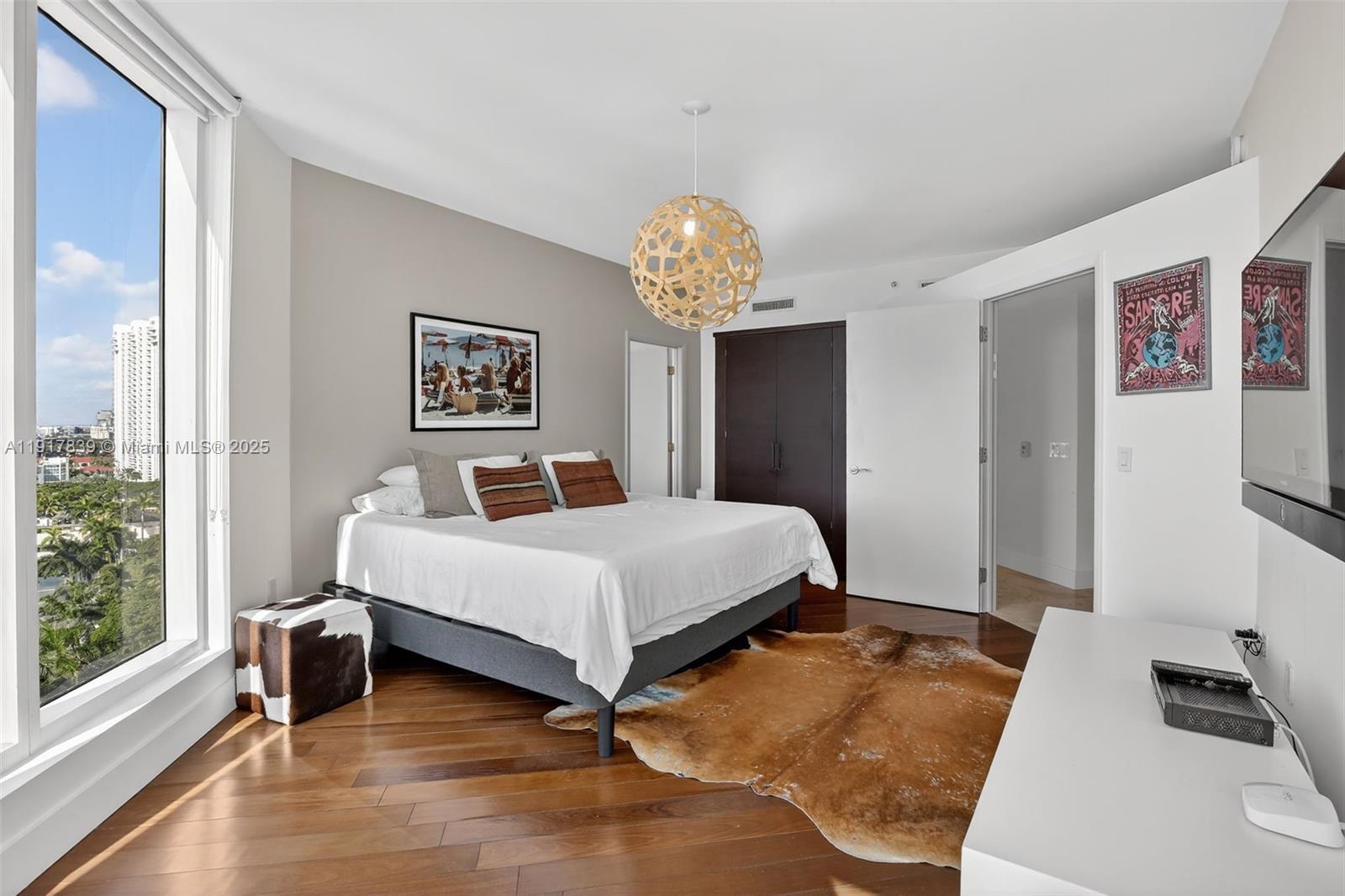 6000 Island Boulevard, Unit 1208 Aventura, FL 33160 - Photo 29 of 50 a bedroom with a bed and a window