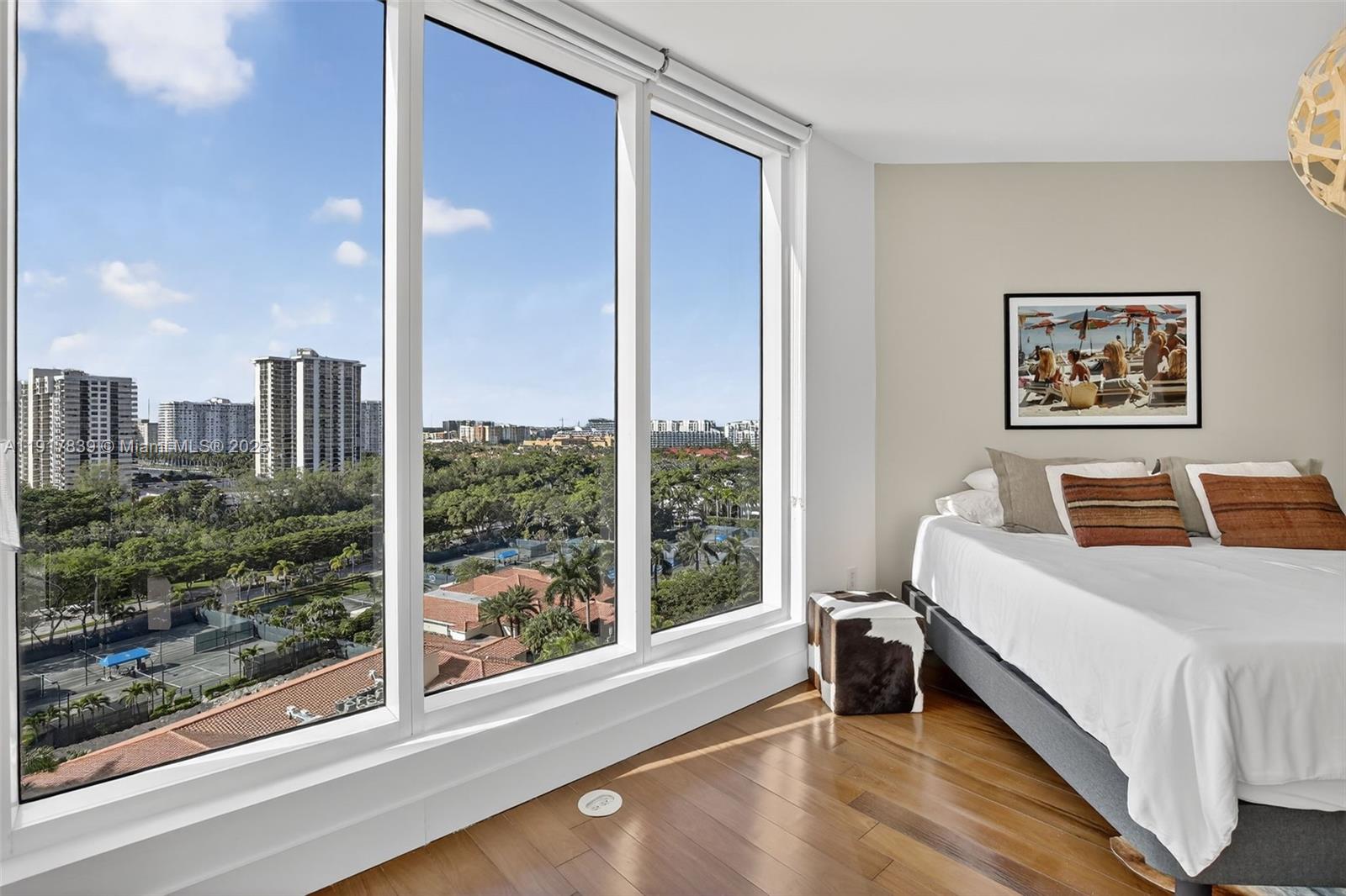 6000 Island Boulevard, Unit 1208 Aventura, FL 33160 - Photo 30 of 50 a bedroom with a bed and a large window with outer view