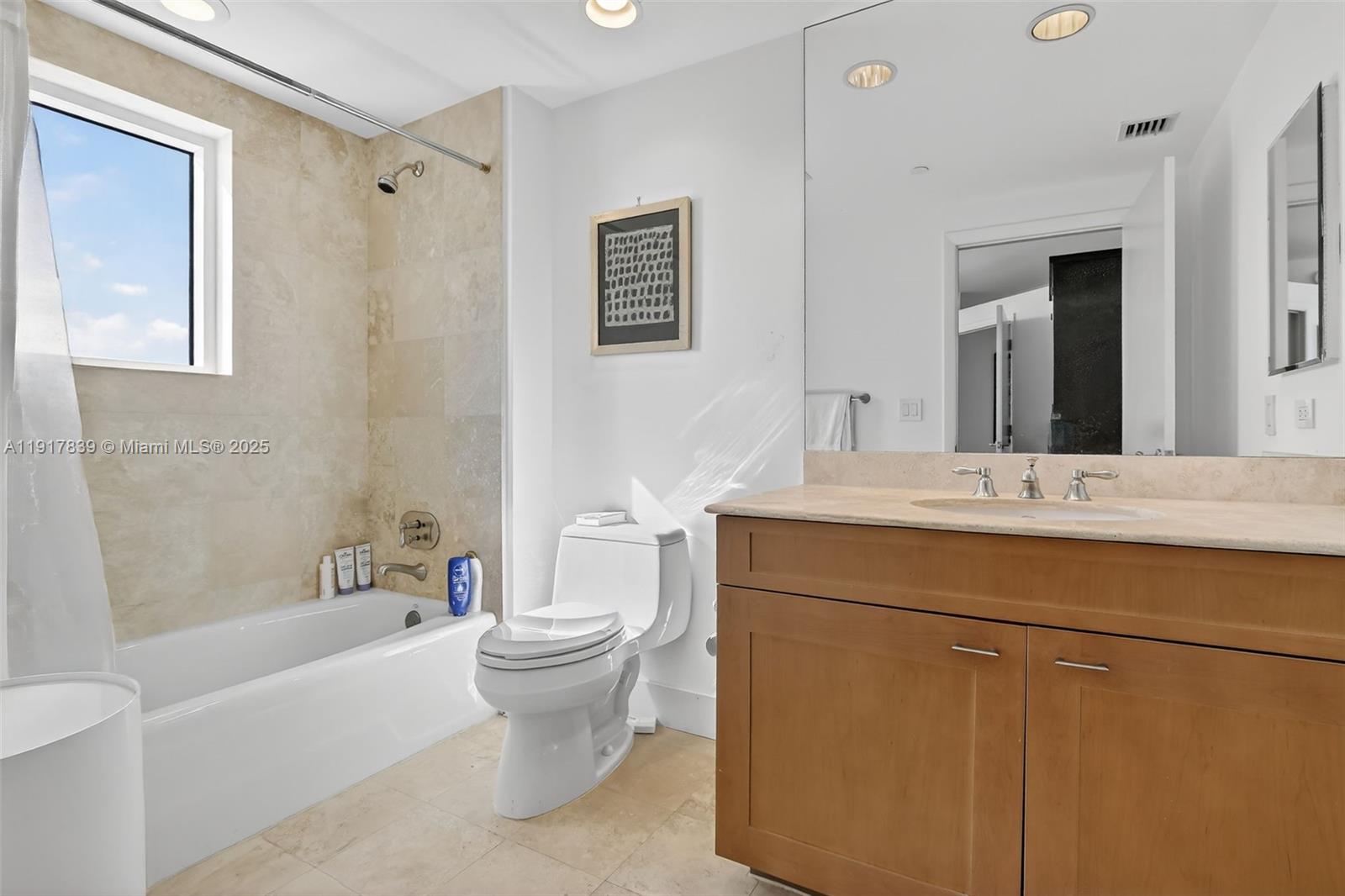 6000 Island Boulevard, Unit 1208 Aventura, FL 33160 - Photo 32 of 50 a bathroom with a bathtub sink mirror and toilet