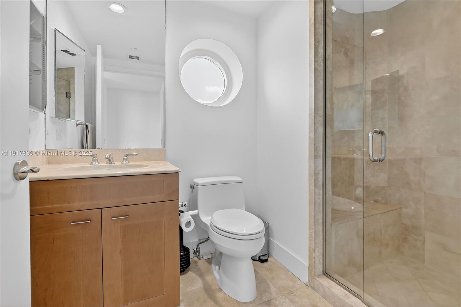 6000 Island Boulevard, Unit 1208 Aventura, FL 33160 - Photo 37 of 50 a bathroom with a sink a toilet and shower