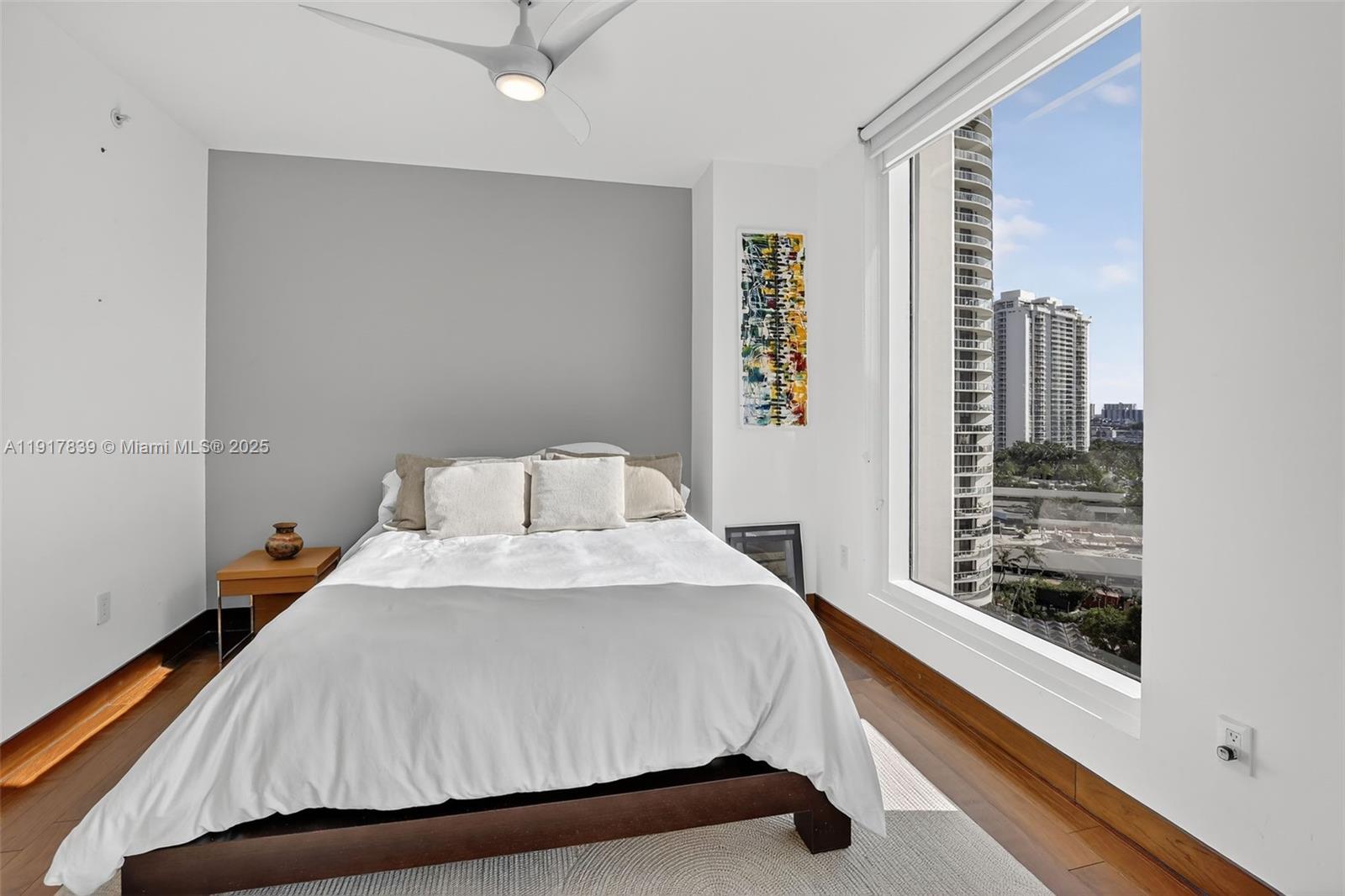 6000 Island Boulevard, Unit 1208 Aventura, FL 33160 - Photo 39 of 50 a bedroom with a bed and window