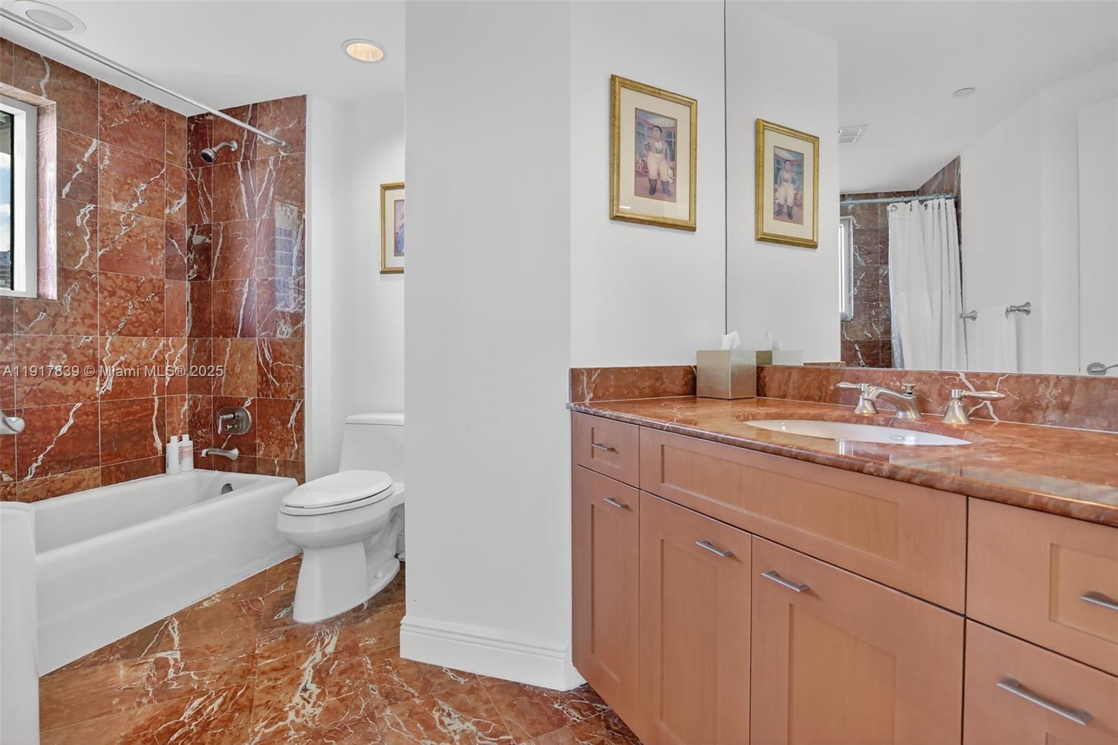 6000 Island Boulevard, Unit 1208 Aventura, FL 33160 - Photo 40 of 50 a bathroom with a sink toilet and shower