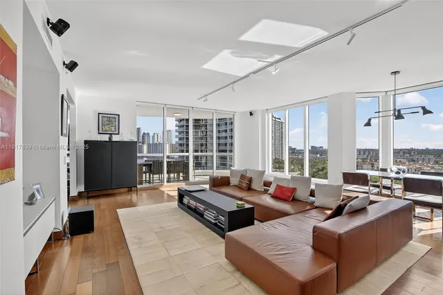 a living room with furniture and large windows