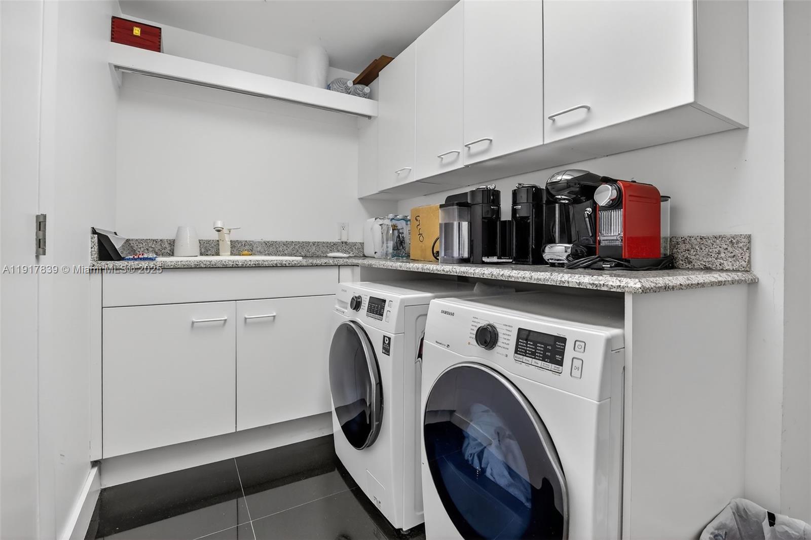6000 Island Boulevard, Unit 1208 Aventura, FL 33160 - Photo 41 of 50 a utility room with dryer and washer