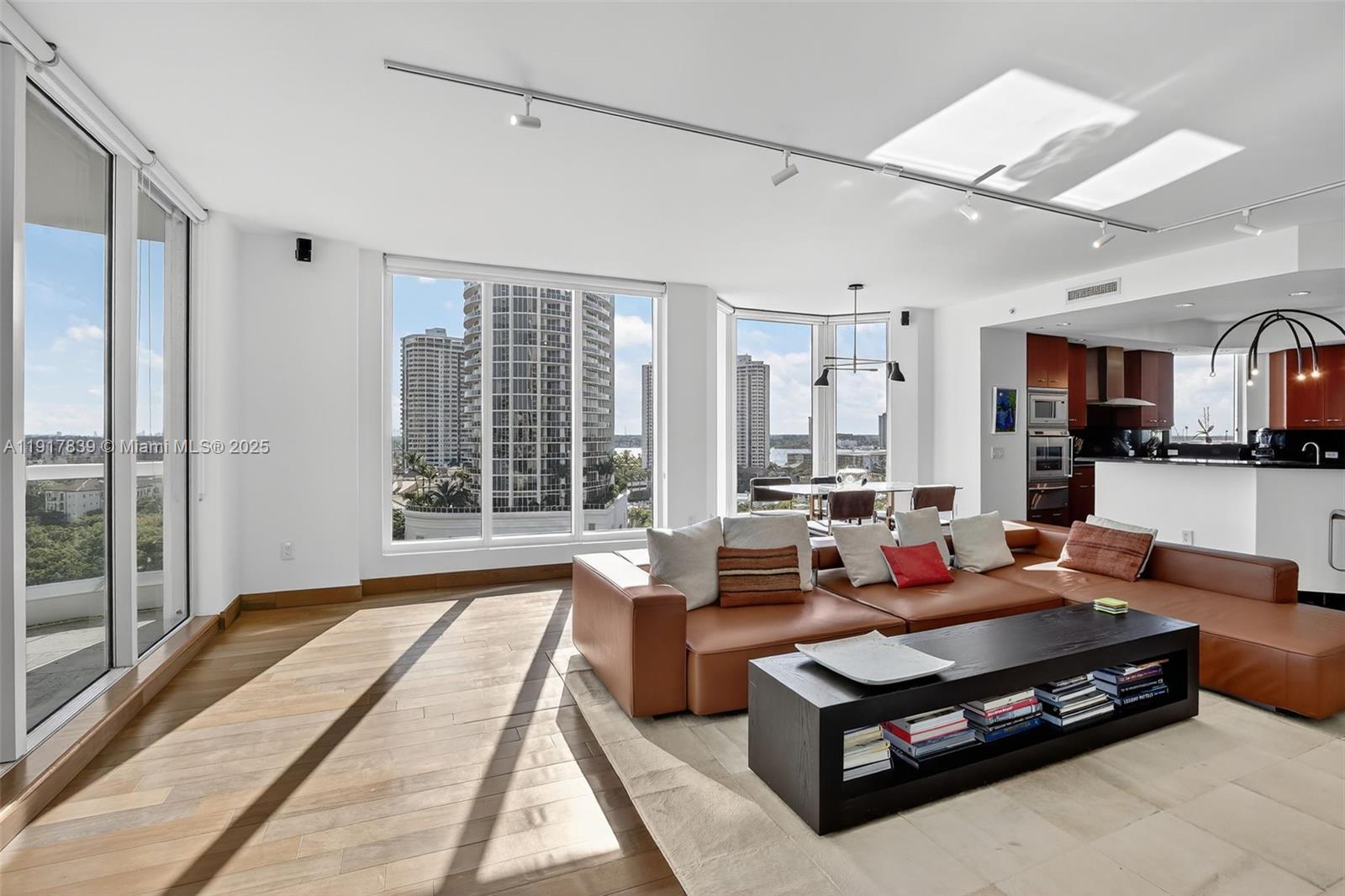 6000 Island Boulevard, Unit 1208 Aventura, FL 33160 - Photo 5 of 50 a living room with furniture large windows and wooden floor