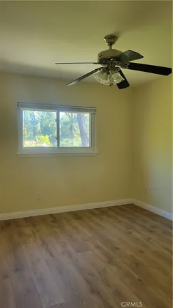a view of a room with window and a ceiling fan