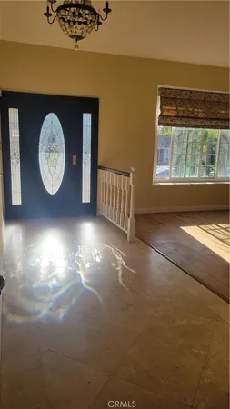 a view of a room with wooden floor and a window