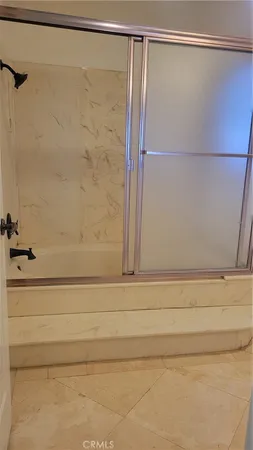 a bathroom with a shower and a shower curtain