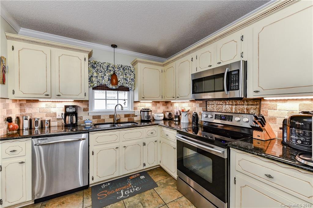 1108 Pinewood Road Rock Hill, SC 29730 - Photo 11 of 26 a kitchen with stainless steel appliances granite countertop grey cabinets a stove a sink and dishwasher