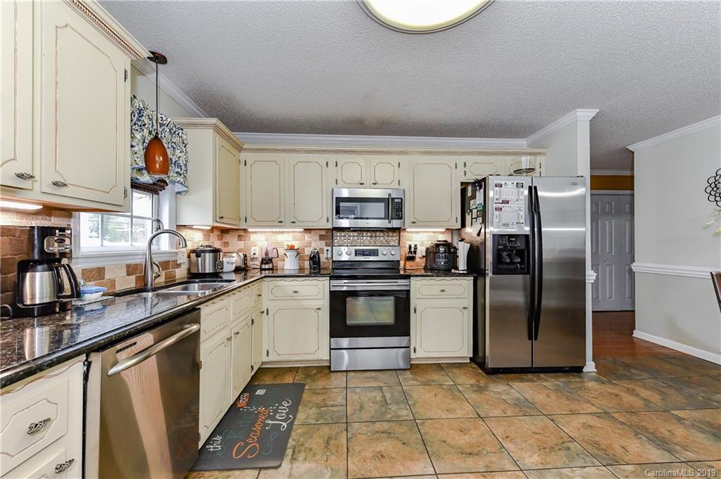 1108 Pinewood Road Rock Hill, SC 29730 - Photo 12 of 26 a kitchen with stainless steel appliances granite countertop a refrigerator a stove and a sink