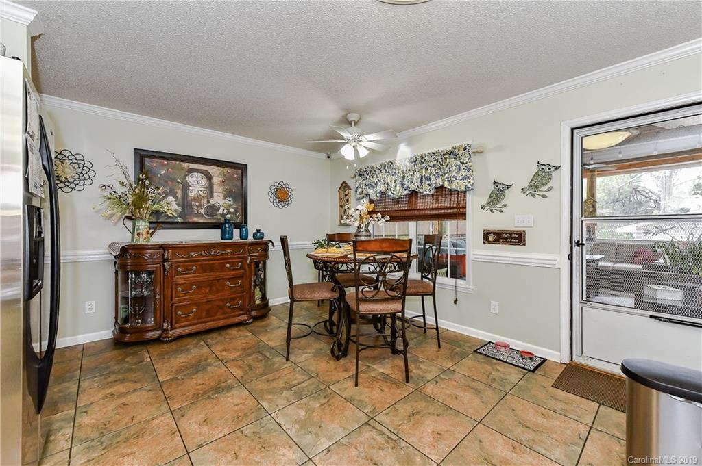 1108 Pinewood Road Rock Hill, SC 29730 - Photo 13 of 26 a dining room filled chandelier and kitchen view