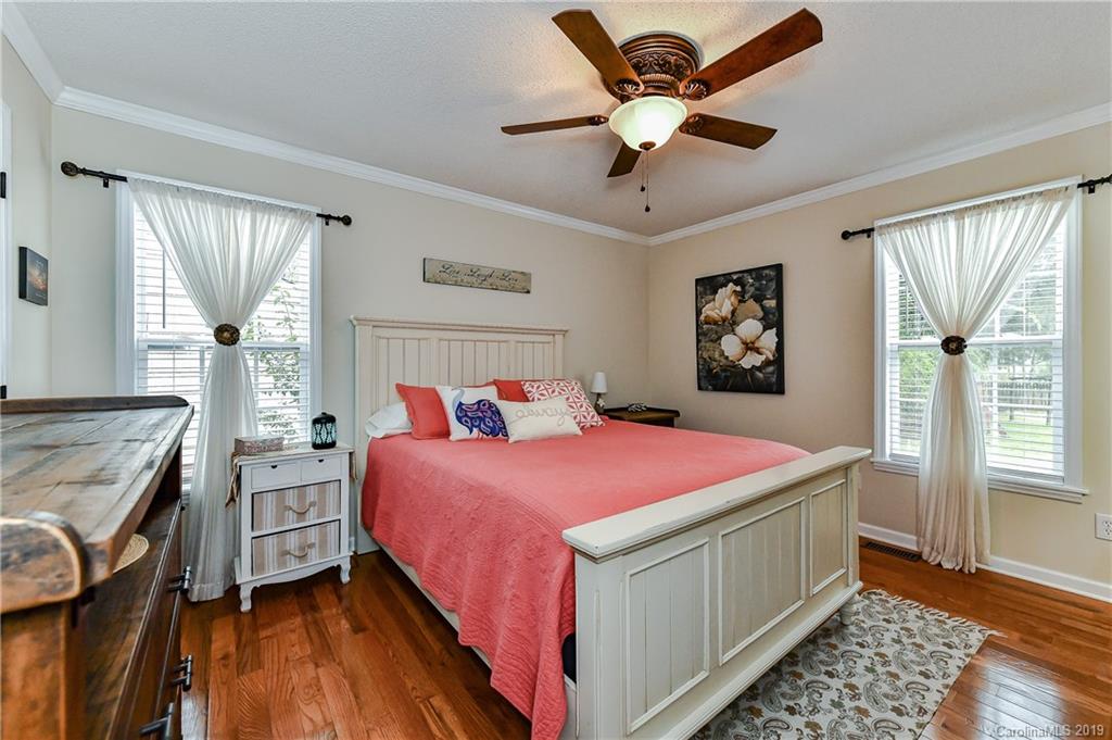 1108 Pinewood Road Rock Hill, SC 29730 - Photo 17 of 26 a bedroom with a bed and a chandelier