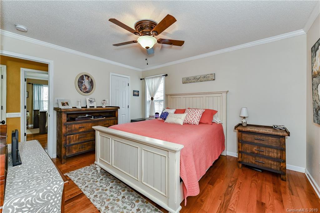 1108 Pinewood Road Rock Hill, SC 29730 - Photo 18 of 26 a spacious bedroom with a bed and a chandelier
