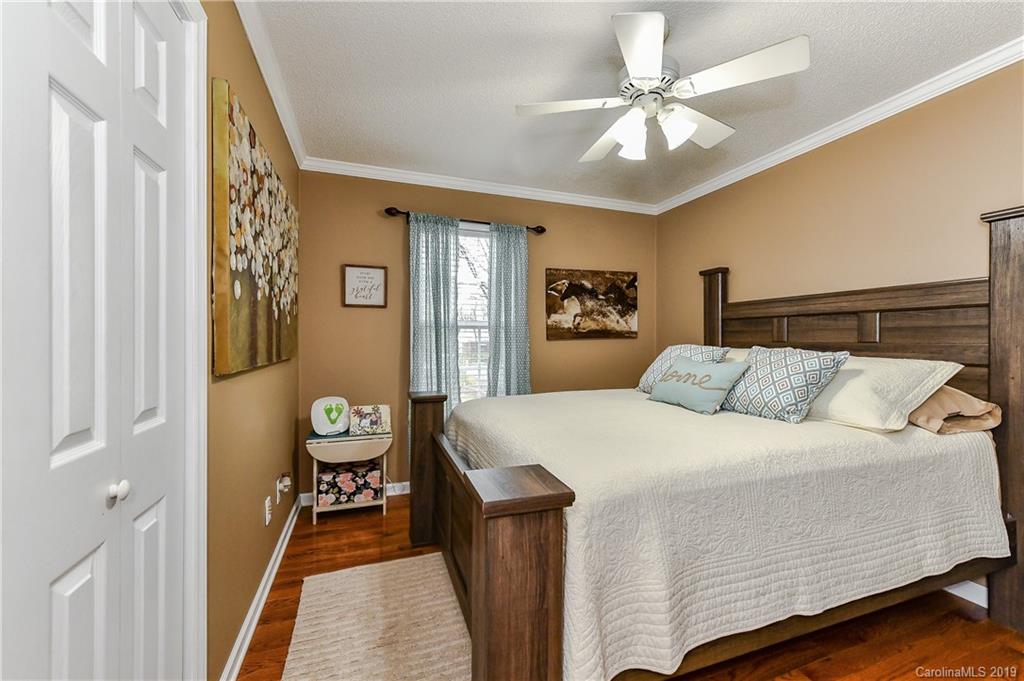 1108 Pinewood Road Rock Hill, SC 29730 - Photo 20 of 26 a bedroom with a bed and a chandelier